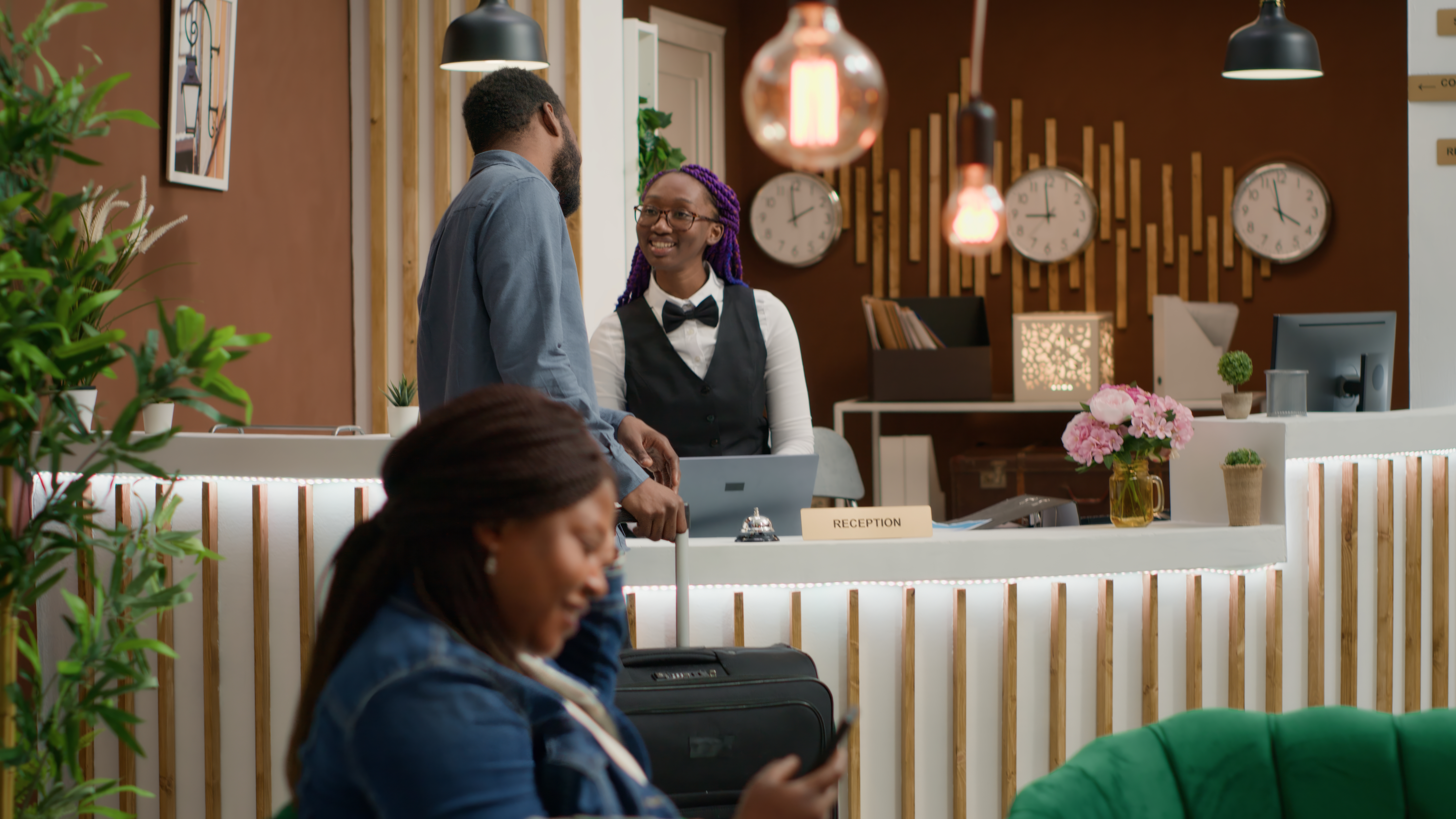 Hotel front-desk professional welcoming guests